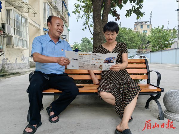  紅色樓棟長向小區住戶宣傳相關政策法規。